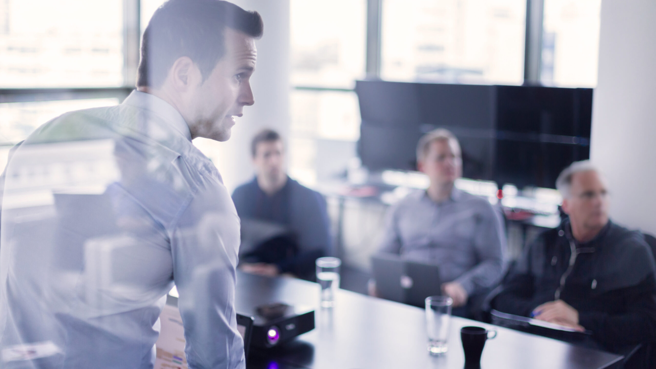 Business,Man,Making,A,Presentation,At,Office.,Business,Executive,Delivering